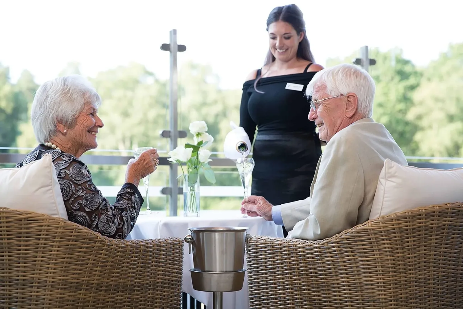 Residents and a member of the team on the terrace at Kings Lodge