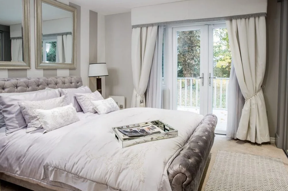 A bedroom suite at Kings Lodge, with doors to the balcony