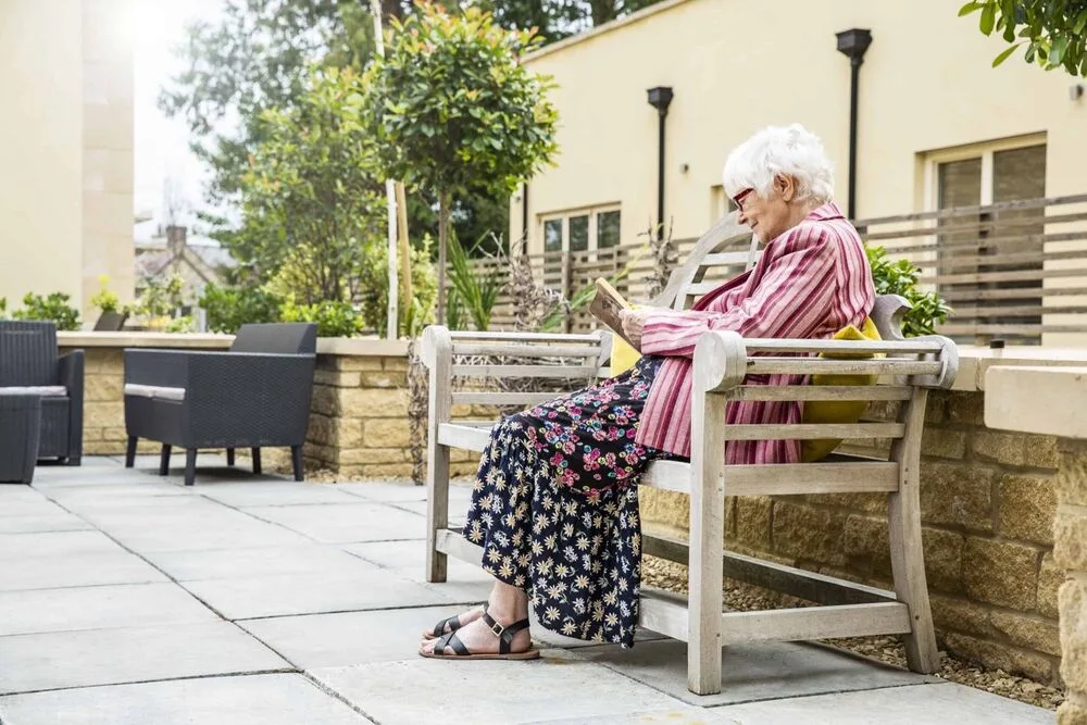 A resident reading on the terrace at Stratton Court