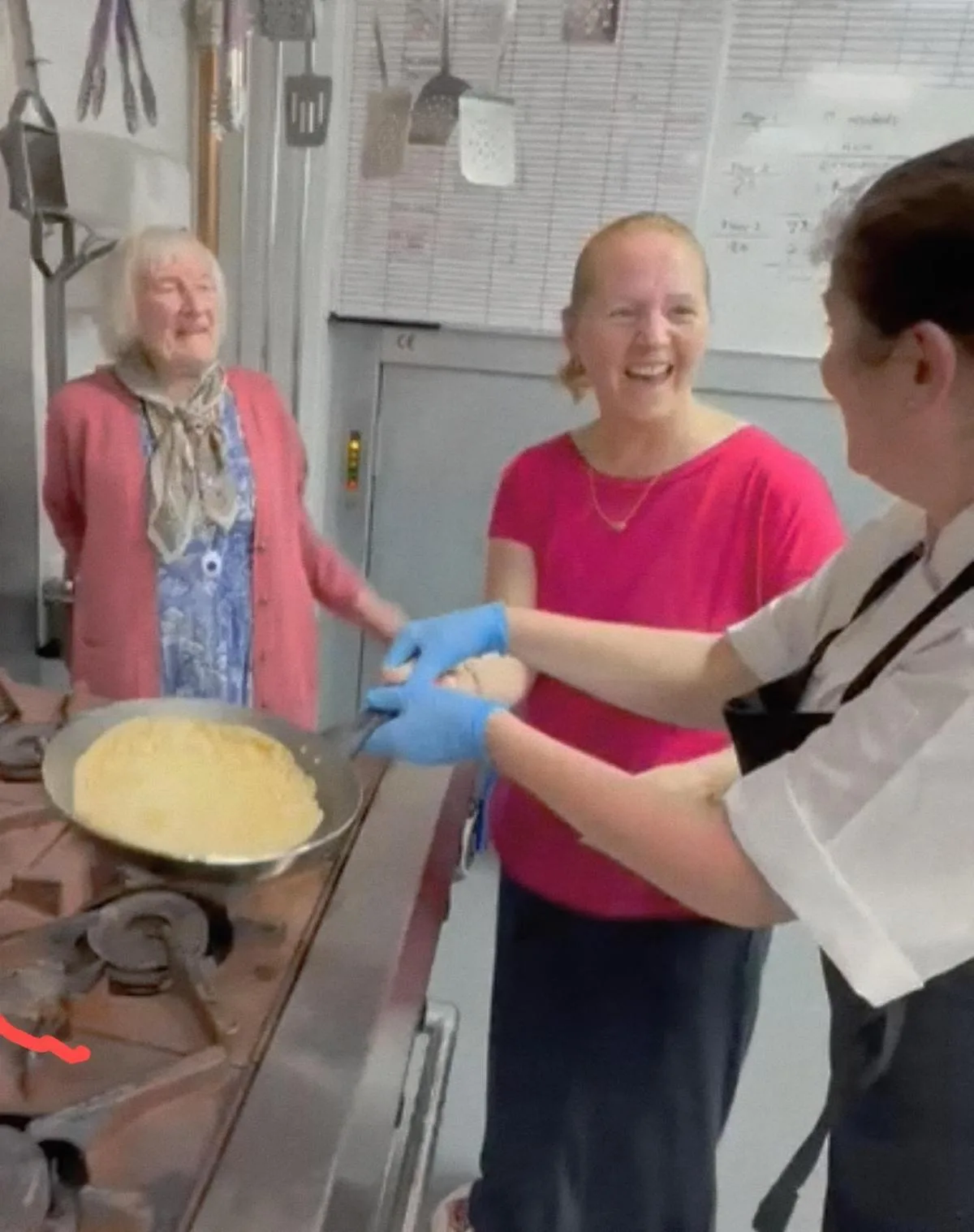 Chef Grace shows them how to flip a pancake