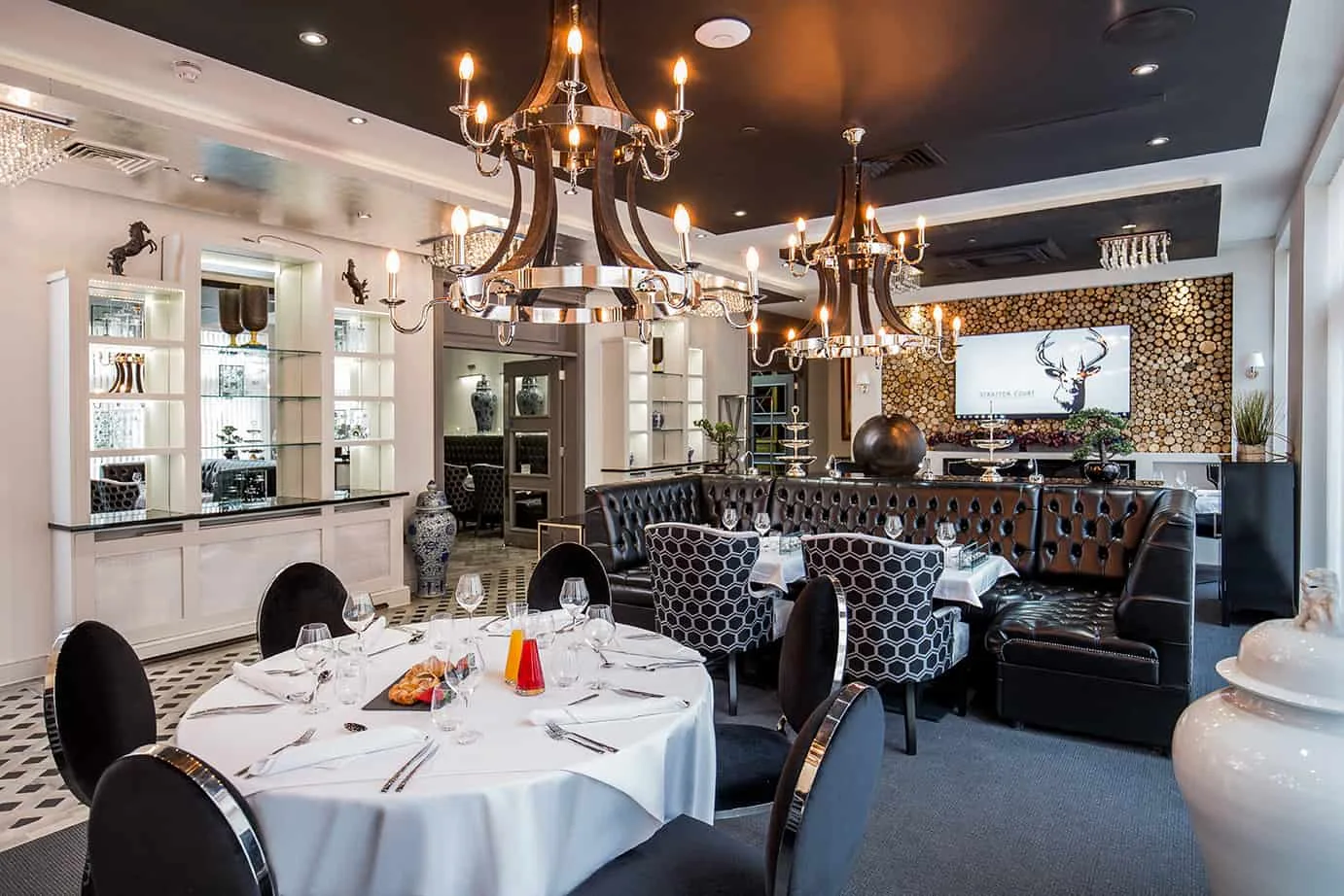 The restaurant at Stratton Court — chandeliers, white linen and the Stratton Court stag